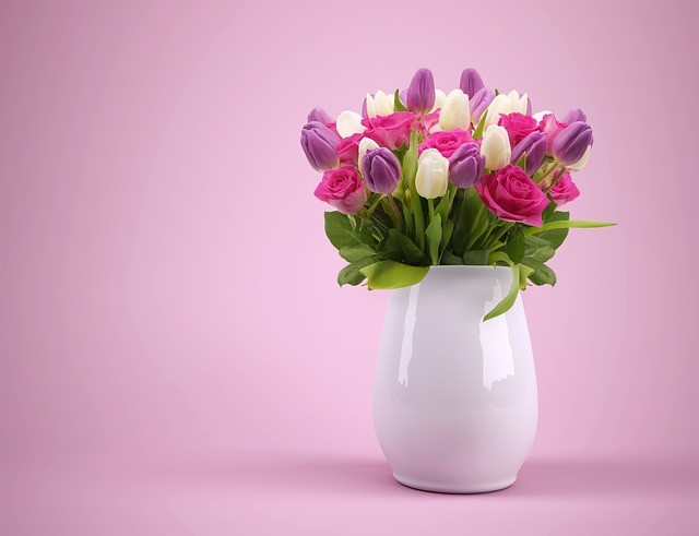 fresh tulips and roses in a ceramic vase